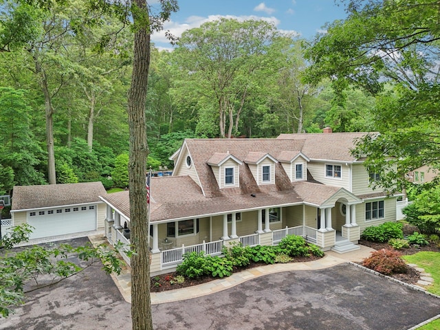 23 Alpine Way S, Huntington, NY 11746 - view of front of house with covered porch, a garage, roof with shingles, an outbuilding, and driveway