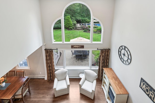 23 Alpine Way S, Huntington, NY 11746 - living area with wood finished floors, healthy amount of natural light, and baseboard heating