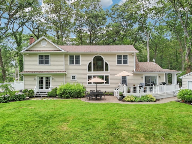 23 Alpine Way S, Huntington, NY 11746 - rear view of house with a chimney, a yard, a wooden deck, french doors, and a patio area