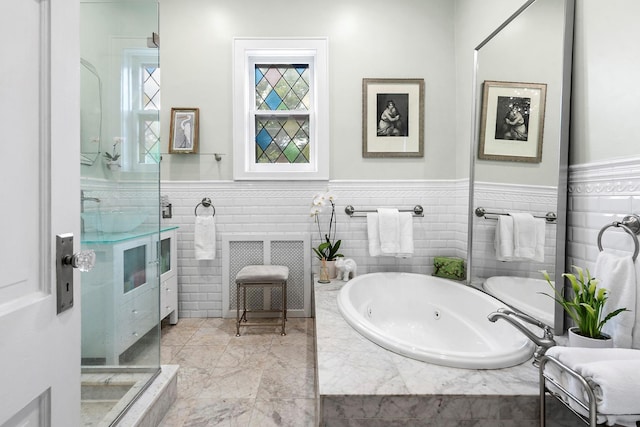 90-01 68th Ave, Forest Hills, NY 11375 - bathroom featuring a whirlpool tub, wainscoting, and tile walls