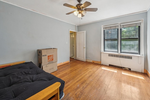 306 E Mosholu Pkwy S Unit 3D, Bronx, NY 10458 - bedroom featuring radiator, wood-type flooring, a ceiling fan, and crown molding