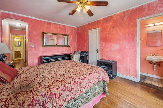 306 E Mosholu Pkwy S Unit 3D, Bronx, NY 10458 - bedroom with wood finished floors, ornamental molding, arched walkways, ensuite bath, and ceiling fan