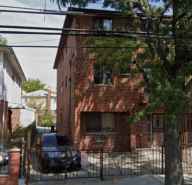 8837 Pitkin Ave, Ozone Park, NY 11417 - view of front of home featuring brick siding, a gate, and a fenced front yard