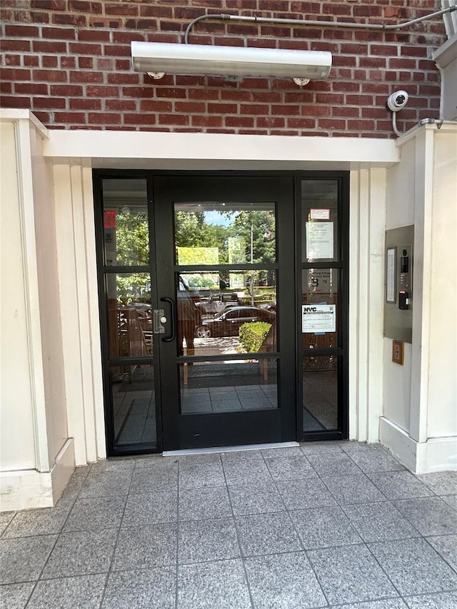 2190 Brigham St Unit 4B, Brooklyn, NY 11229 - doorway to property featuring brick siding, french doors, and a security system