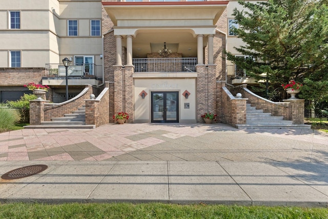 257 Central Ave Unit 1D, White Plains, NY 10606 - doorway to property with french doors, stucco siding, and brick siding