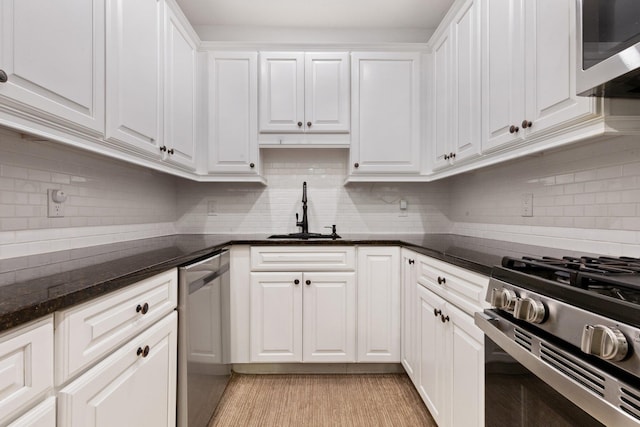 257 Central Ave Unit 1D, White Plains, NY 10606 - kitchen with stainless steel appliances, white cabinetry, tasteful backsplash, and dark stone countertops