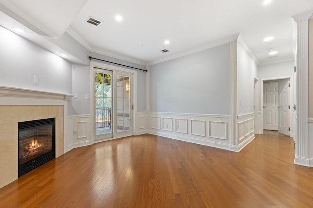 257 Central Ave Unit 1D, White Plains, NY 10606 - unfurnished living room with wood finished floors, a tile fireplace, wainscoting, crown molding, and recessed lighting