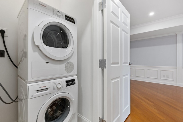 257 Central Ave Unit 1D, White Plains, NY 10606 - washroom with stacked washer / dryer, wood finished floors, and ornamental molding