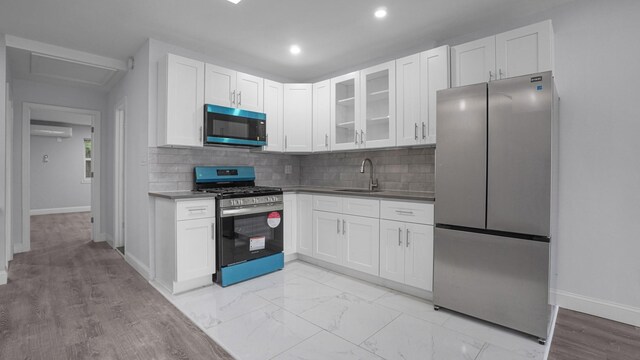 3604 Willett Ave, Bronx, NY 10467 - kitchen with stainless steel appliances, white cabinetry, glass insert cabinets, tasteful backsplash, and a wall unit AC