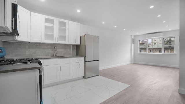 3604 Willett Ave, Bronx, NY 10467 - kitchen with appliances with stainless steel finishes, recessed lighting, white cabinets, backsplash, and glass insert cabinets