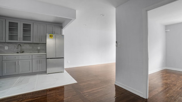 3604 Willett Ave, Bronx, NY 10467 - kitchen featuring freestanding refrigerator, gray cabinets, glass insert cabinets, light countertops, and wood finished floors
