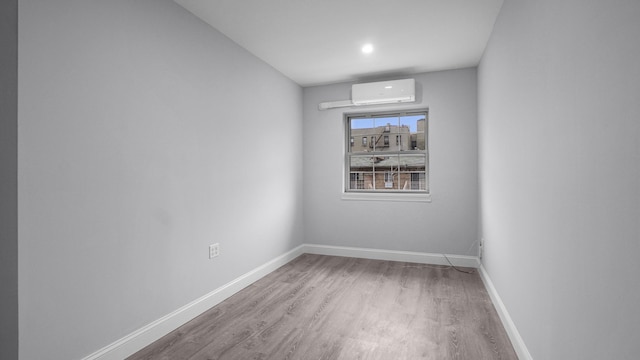 3604 Willett Ave, Bronx, NY 10467 - unfurnished room with a wall unit AC, wood finished floors, and recessed lighting
