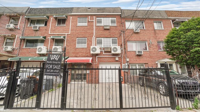 3604 Willett Ave, Bronx, NY 10467 - view of front of home featuring brick siding, a garage, and a fenced front yard