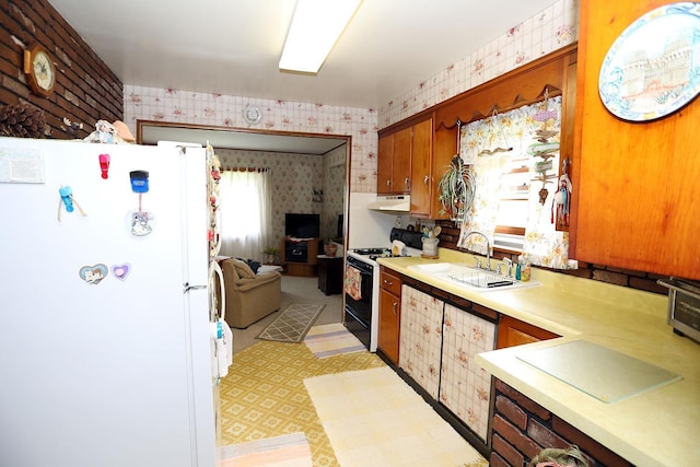 3027 State Route 17b, Cochecton, NY 12726 - kitchen with freestanding refrigerator, wallpapered walls, black gas stove, under cabinet range hood, and light countertops