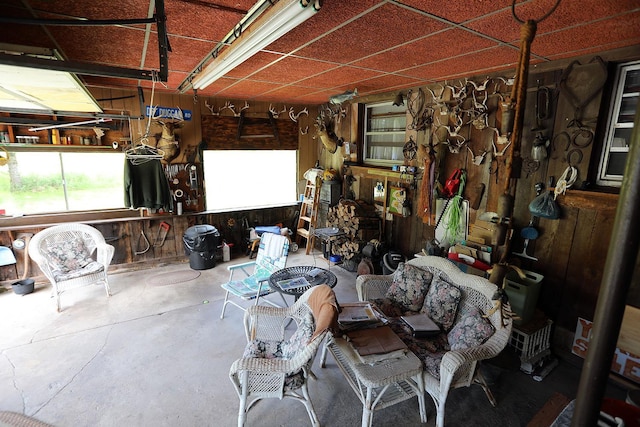 3027 State Route 17b, Cochecton, NY 12726 - miscellaneous room featuring wood walls, concrete floors, and a workshop area