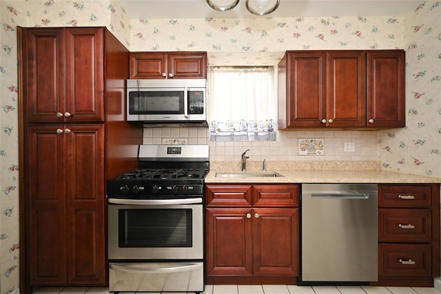 43-44 168th St, Flushing, NY 11358 - kitchen featuring stainless steel appliances, wallpapered walls, dark brown cabinets, light countertops, and tasteful backsplash