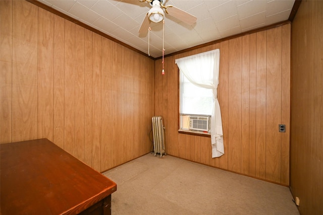 43-44 168th St, Flushing, NY 11358 - carpeted empty room featuring radiator heating unit, cooling unit, wood walls, and ceiling fan