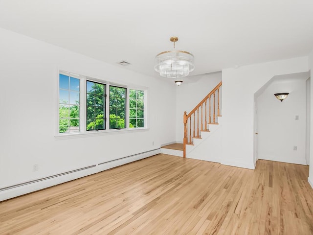 17 Shenorock Dr, Yorktown Heights, NY 10598 - unfurnished room featuring a baseboard radiator, wood finished floors, stairway, a chandelier, and arched walkways