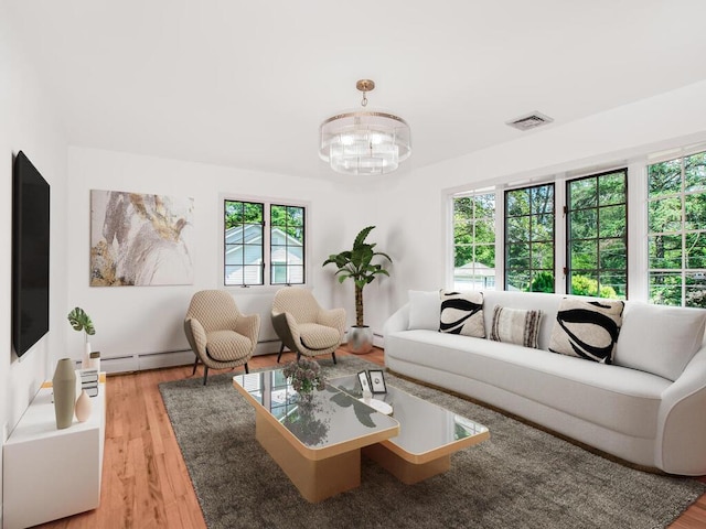 17 Shenorock Dr, Yorktown Heights, NY 10598 - living room featuring light wood finished floors, baseboard heating, and a chandelier