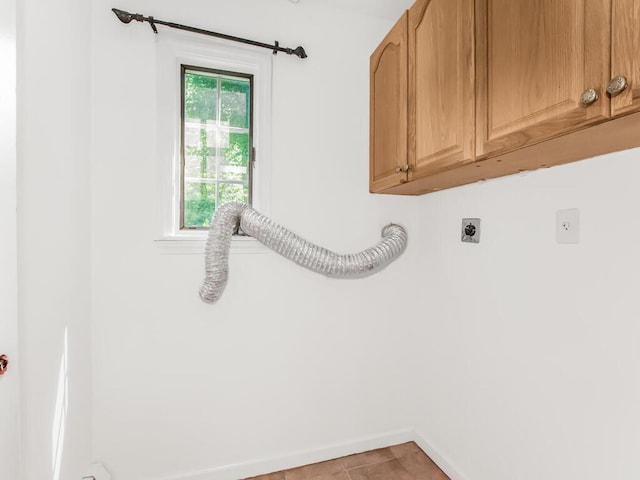 17 Shenorock Dr, Yorktown Heights, NY 10598 - laundry room featuring electric dryer hookup, cabinet space, and light tile patterned flooring
