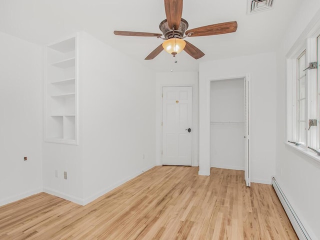 17 Shenorock Dr, Yorktown Heights, NY 10598 - unfurnished room with a baseboard radiator, light wood-type flooring, and plenty of natural light