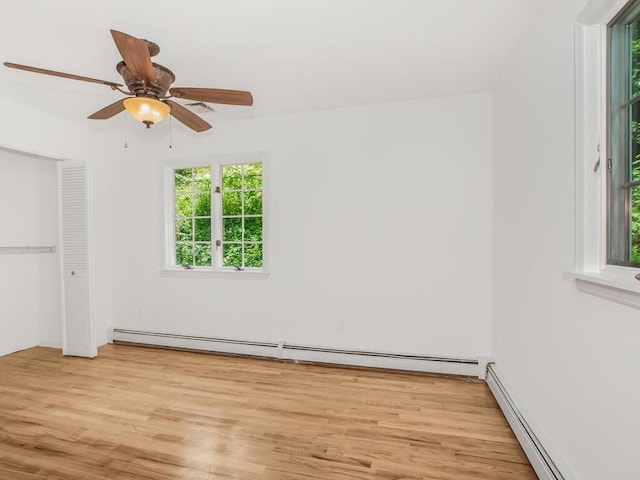 17 Shenorock Dr, Yorktown Heights, NY 10598 - unfurnished bedroom with a baseboard heating unit, light wood finished floors, a baseboard radiator, ceiling fan, and a closet
