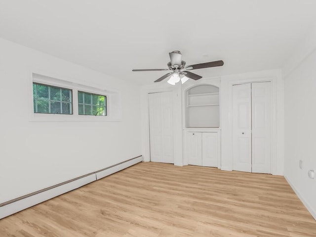 17 Shenorock Dr, Yorktown Heights, NY 10598 - unfurnished bedroom with a baseboard heating unit, two closets, light wood-type flooring, and ceiling fan