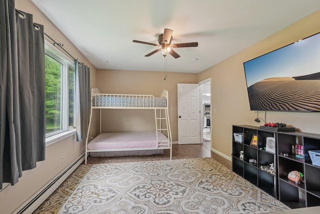 24 Wild Turkey Run, Wappingers Falls, NY 12590 - bedroom featuring baseboard heating, wood finished floors, and a ceiling fan