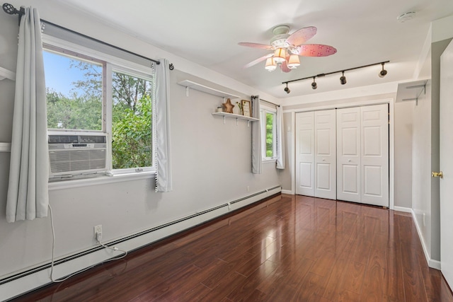 24 Wild Turkey Run, Wappingers Falls, NY 12590 - unfurnished bedroom featuring a baseboard radiator, rail lighting, wood finished floors, cooling unit, and a closet