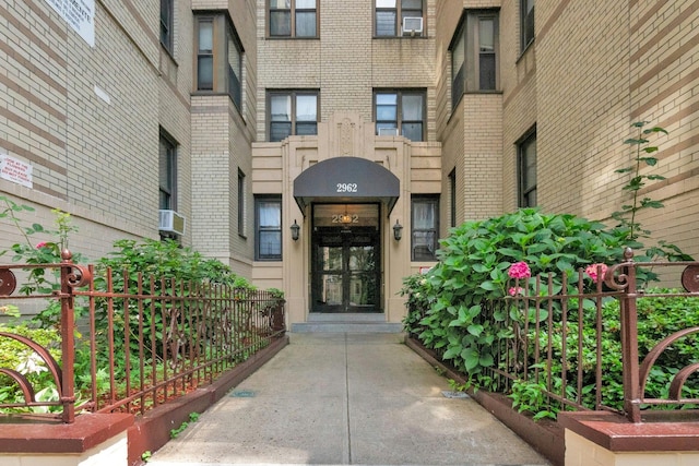 2962 Decatur Ave Unit 1C, Bronx, NY 10458 - entrance to property with brick siding, cooling unit, and french doors