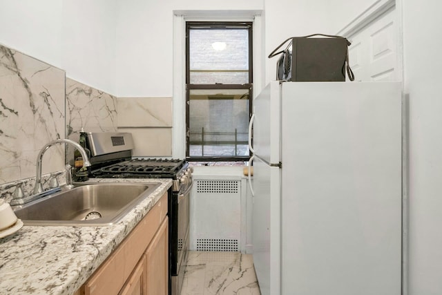 2962 Decatur Ave Unit 1C, Bronx, NY 10458 - kitchen featuring freestanding refrigerator, stainless steel gas range oven, light marble finish floors, light brown cabinets, and light countertops