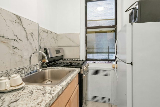 2962 Decatur Ave Unit 1C, Bronx, NY 10458 - kitchen featuring freestanding refrigerator, gas range, light countertops, light brown cabinetry, and backsplash