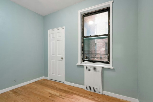 2962 Decatur Ave Unit 1C, Bronx, NY 10458 - unfurnished room with radiator heating unit and light wood-style flooring