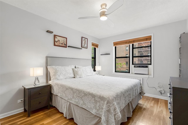 620 W 239th St Unit 2C, Bronx, NY 10463 - bedroom with light wood-type flooring, radiator, a ceiling fan, and cooling unit
