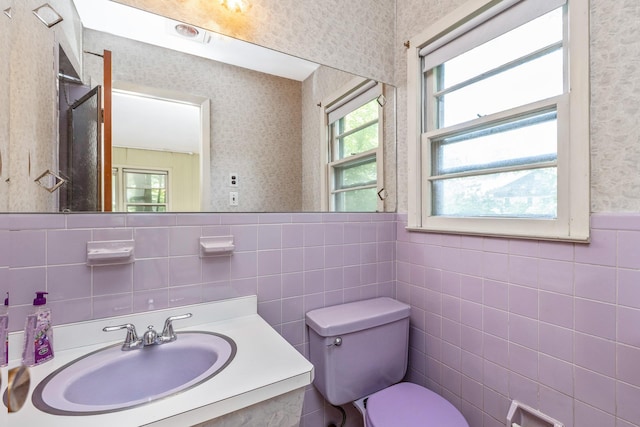 15 Carol Ct, Dix Hills, NY 11746 - bathroom featuring wallpapered walls, plenty of natural light, tile walls, vanity, and a wainscoted wall