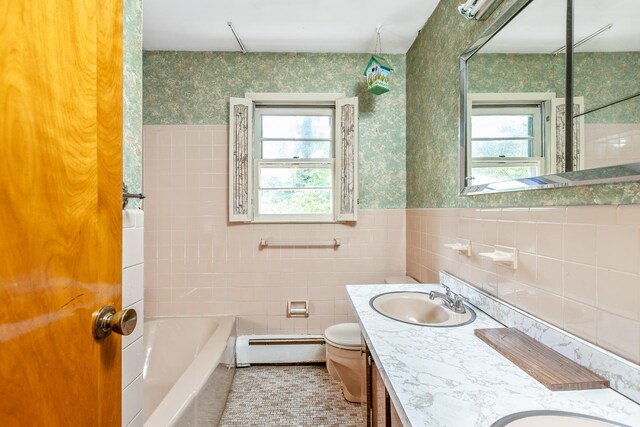 15 Carol Ct, Dix Hills, NY 11746 - full bathroom featuring a baseboard heating unit, healthy amount of natural light, double vanity, a tub, and wallpapered walls