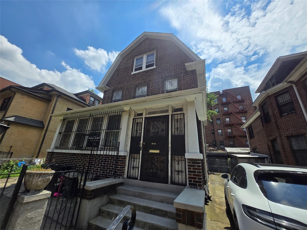 40-44 Hampton St, Elmhurst, NY 11373 - view of front of property featuring brick siding and a gambrel roof