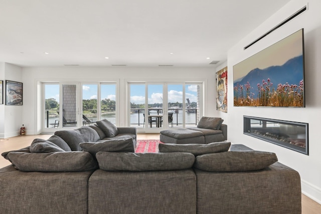 720 Davenport Ave Unit 3, New Rochelle, NY 10805 - living area with healthy amount of natural light, a glass covered fireplace, wood finished floors, and recessed lighting