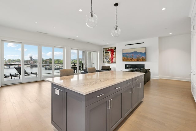 720 Davenport Ave Unit 3, New Rochelle, NY 10805 - kitchen with open floor plan, light wood-type flooring, gray cabinets, hanging light fixtures, and recessed lighting