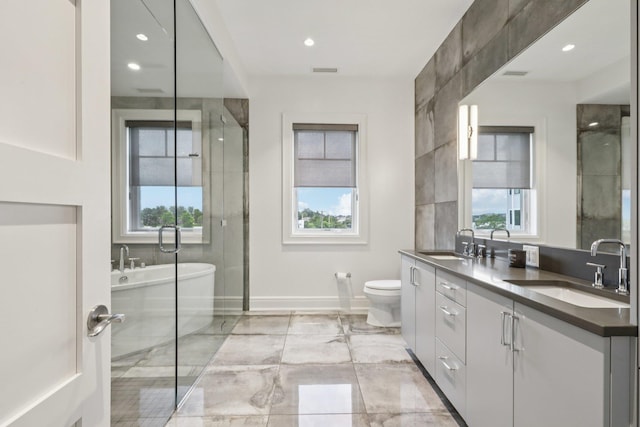 720 Davenport Ave Unit 3, New Rochelle, NY 10805 - bathroom featuring double vanity, healthy amount of natural light, a freestanding tub, marble tiled floors, and recessed lighting