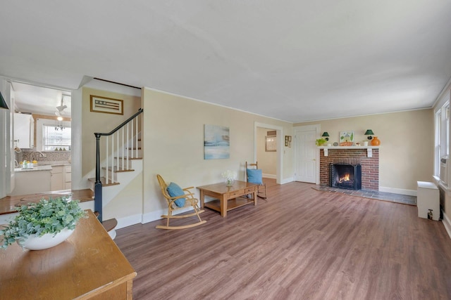 23 Jackson Ave, White Plains, NY 10606 - living room with wood finished floors, stairs, and a brick fireplace