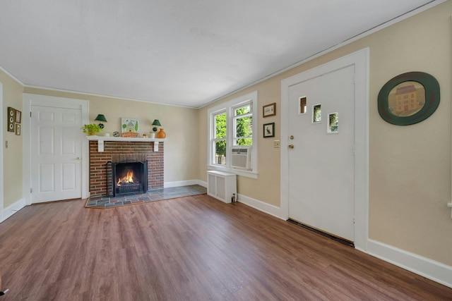 23 Jackson Ave, White Plains, NY 10606 - unfurnished living room featuring wood finished floors, radiator heating unit, ornamental molding, a fireplace, and cooling unit