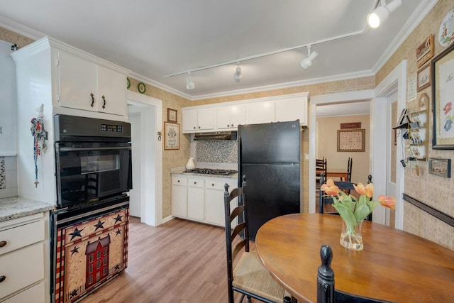 23 Jackson Ave, White Plains, NY 10606 - kitchen featuring black appliances, rail lighting, light wood-style flooring, white cabinetry, and ornamental molding