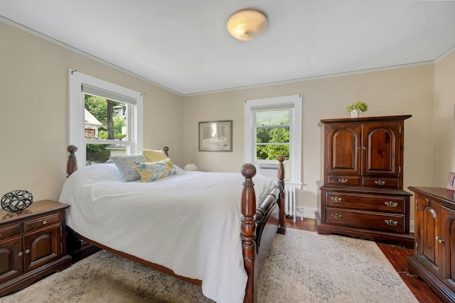 23 Jackson Ave, White Plains, NY 10606 - bedroom featuring radiator heating unit, dark wood-type flooring, and crown molding