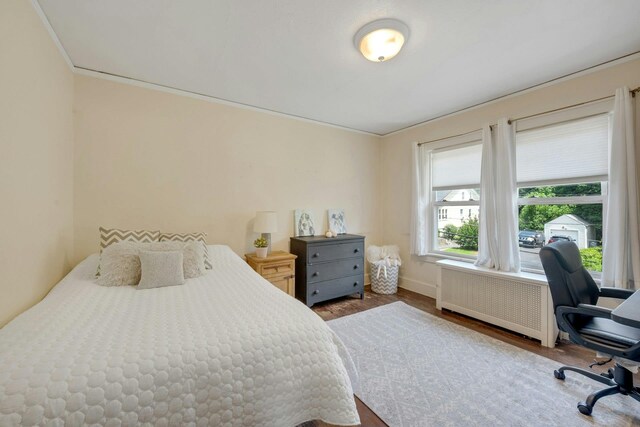 23 Jackson Ave, White Plains, NY 10606 - bedroom featuring radiator, wood finished floors, an office area, and ornamental molding