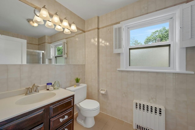 23 Jackson Ave, White Plains, NY 10606 - full bathroom with radiator heating unit, tile walls, vanity, a shower with door, and tile patterned flooring