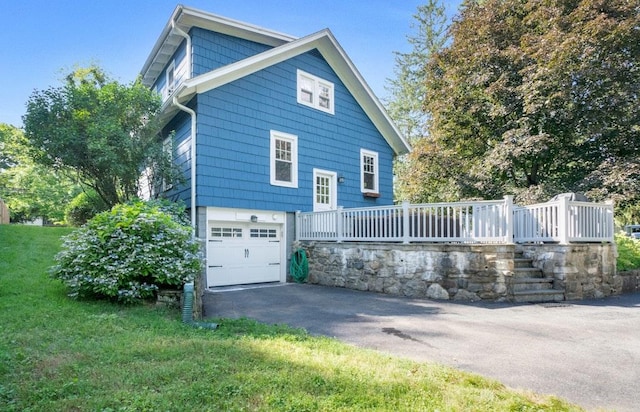 400 Saw Mill River Rd, Millwood, NY 10546 - view of side of home with asphalt driveway, an attached garage, a wooden deck, and a lawn