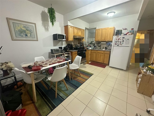31-67 44th St, Astoria, NY 11103 - kitchen with stainless steel appliances, light tile patterned floors, and under cabinet range hood