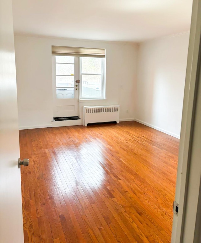 1133 Midland Ave Unit 1K, Yonkers, NY 10708 - unfurnished room with radiator heating unit and hardwood / wood-style floors