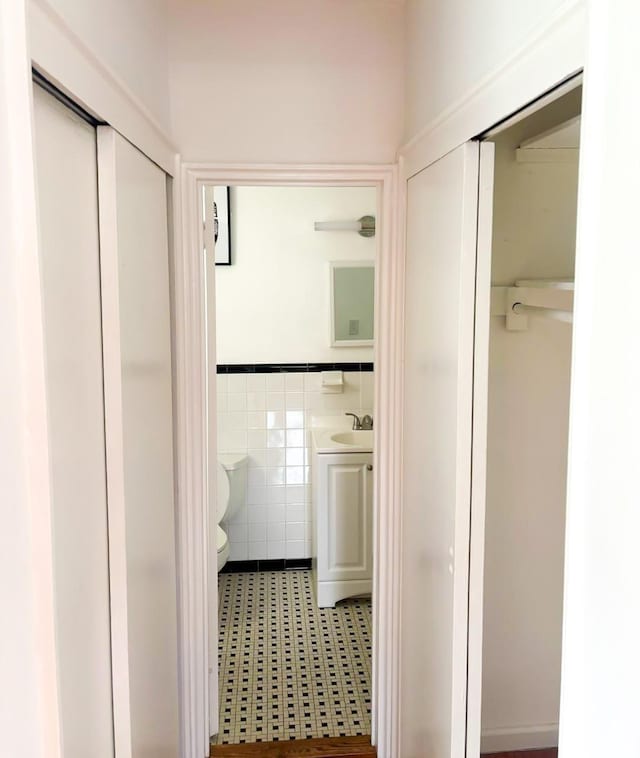 1133 Midland Ave Unit 1K, Yonkers, NY 10708 - corridor with tile walls, a wainscoted wall, and tile patterned flooring